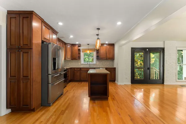 a kitchen with a refrigerator and a sink