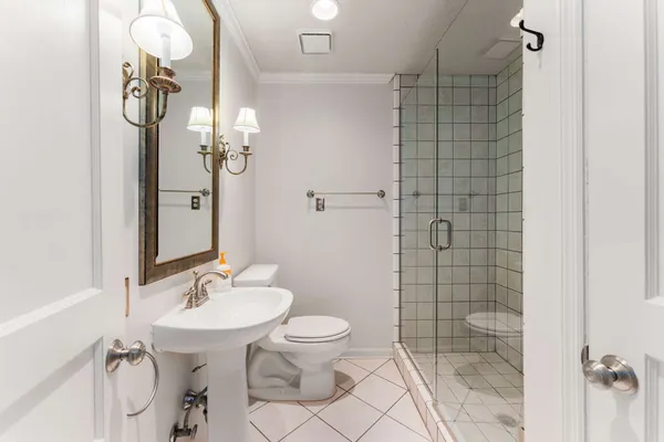 a bathroom with a sink toilet and shower