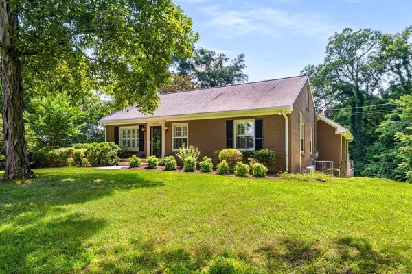 a front view of house with yard and green space