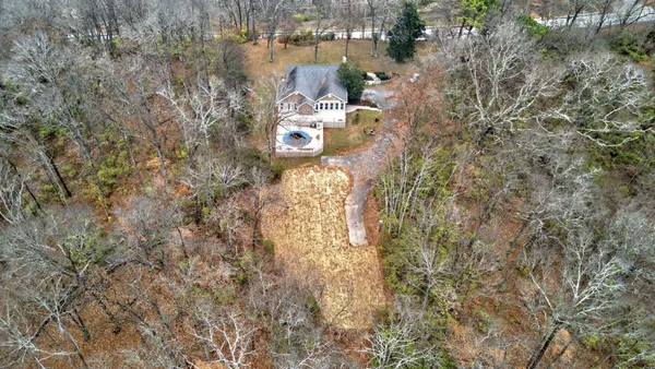 an aerial view of a backyard with chairs and a fire pit
