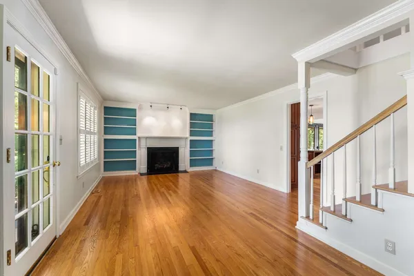 a view of a livingroom with wooden floor and fireplace
