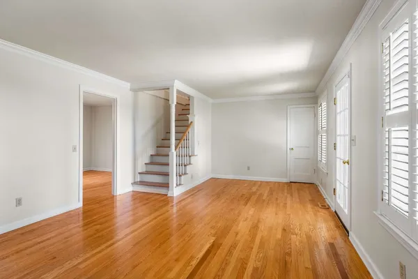 wooden floor in an empty room with a window