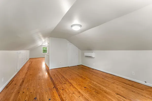 a view of a room with wooden floor and window