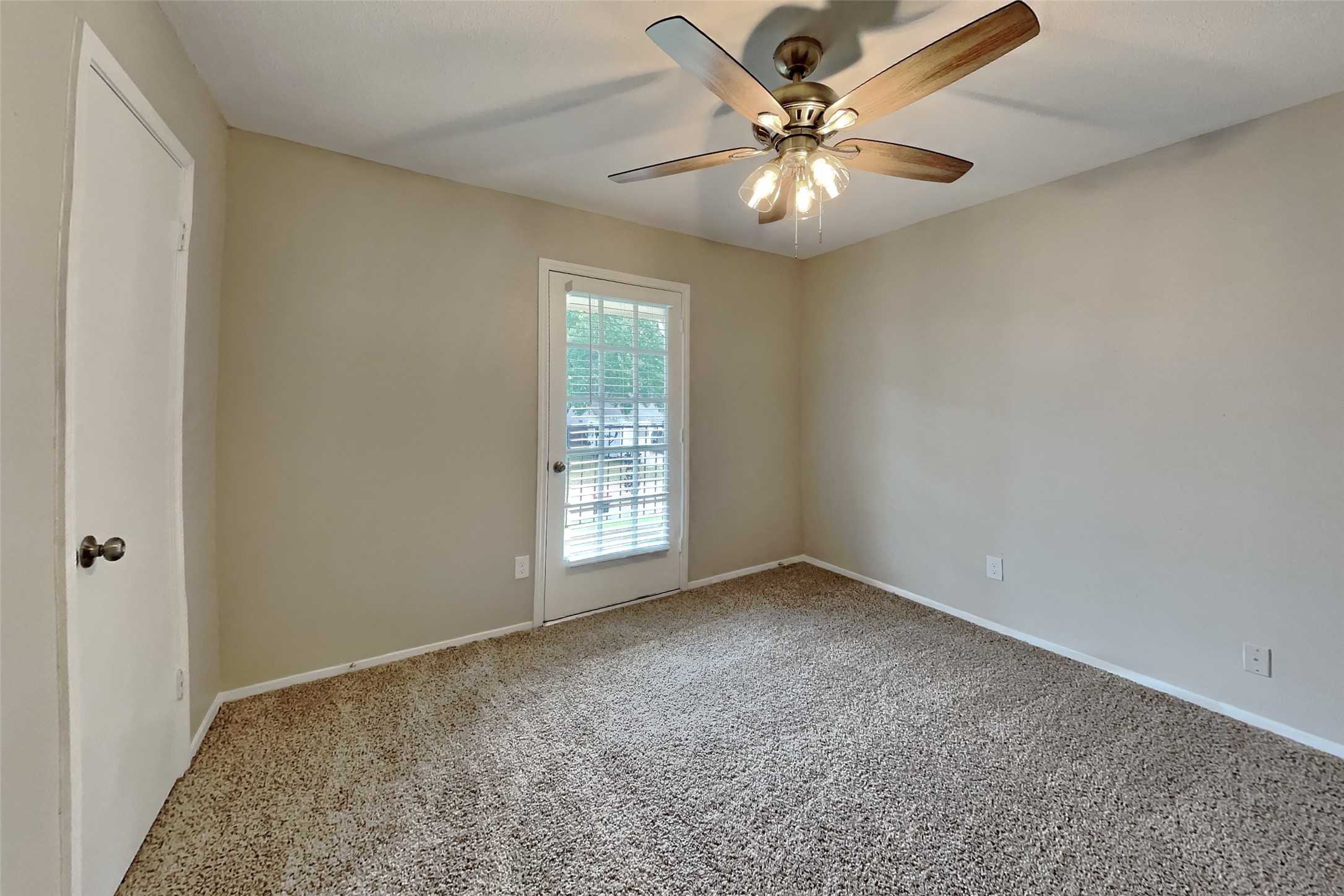10015 Rippling Fields Drive Houston, TX 77064 - Photo 18 of 24 an empty room with windows and fan