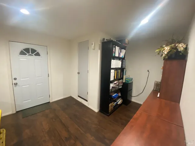 a view of an entryway with wooden floor