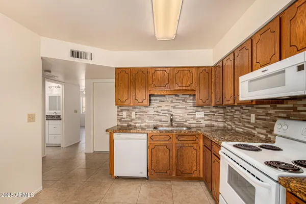 a kitchen with a sink stove and cabinets
