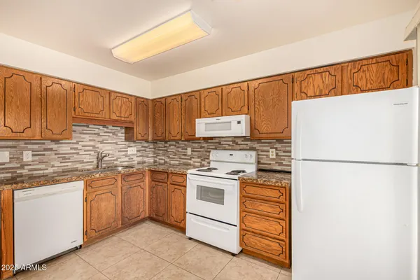 a kitchen with a white cabinets and white appliances