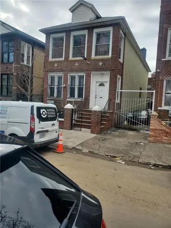 a car parked in front of a brick house