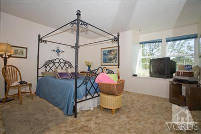 1131 Rivas Lane Oxnard, CA 93035 - Photo 7 of 10 a living room with furniture a flat screen tv and a floor to ceiling window