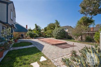 1131 Rivas Lane Oxnard, CA 93035 - Photo 9 of 10 a pathway of a house with yard and trees in the background