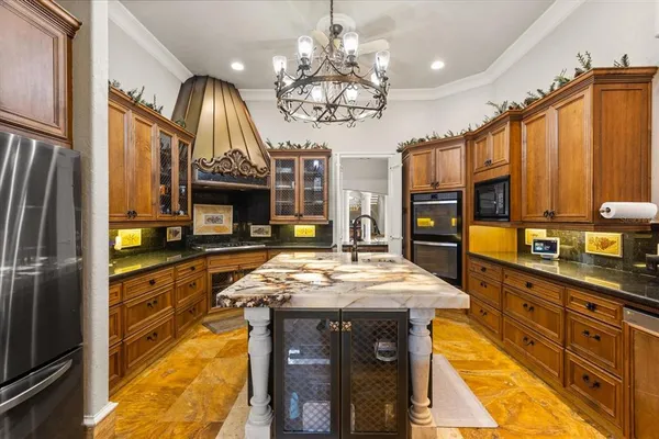 a living room with fireplace furniture and a chandelier