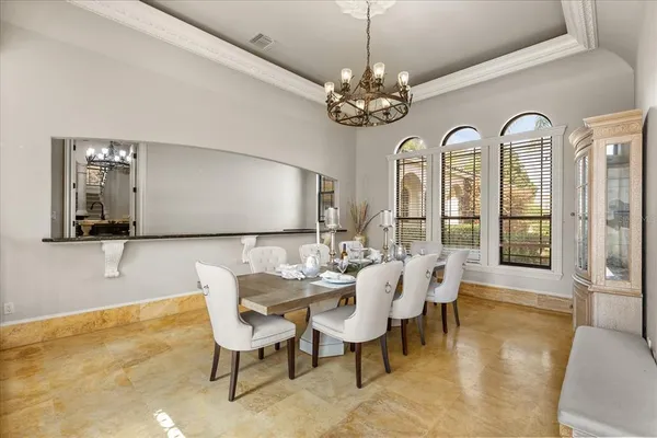 a spacious bathroom with a granite countertop double vanity sink a mirror and a bathtub