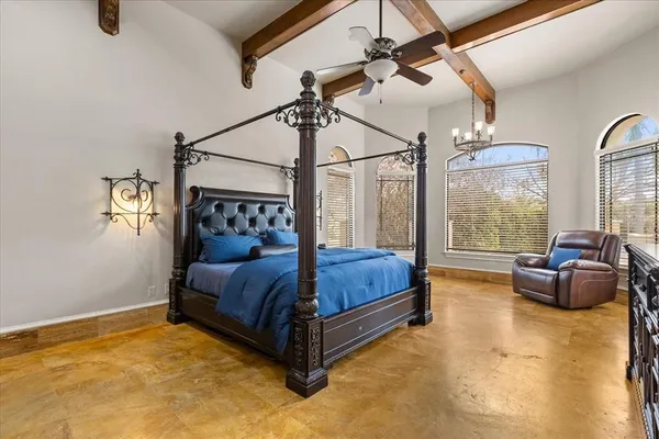 a bedroom with a bed and large window