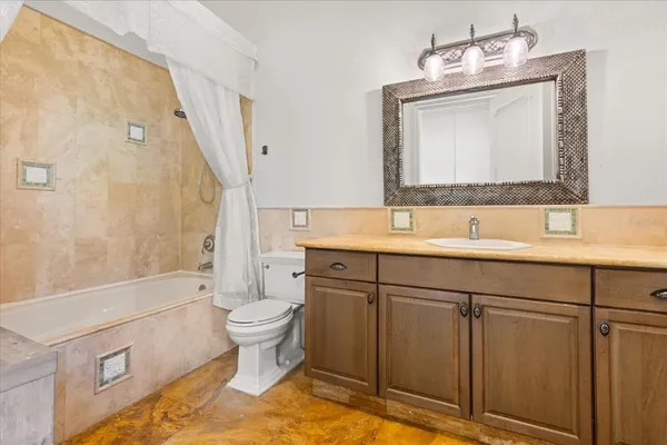 a view of a swimming pool with a table and chairs under an umbrella