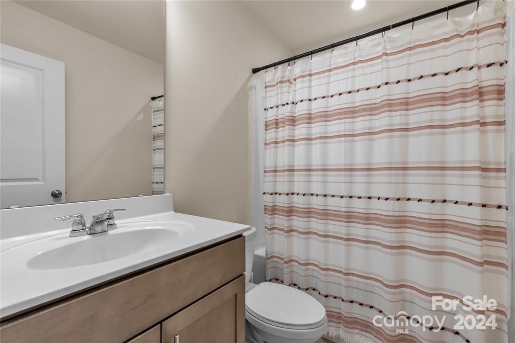 825 Canoe Song Road Fort Mill, SC 29708 - Photo 11 of 17 a bathroom with a sink a toilet and shower curtain