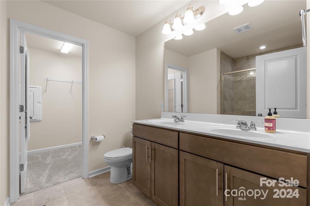 825 Canoe Song Road Fort Mill, SC 29708 - Photo 13 of 17 a bathroom with a sink a toilet and a mirror