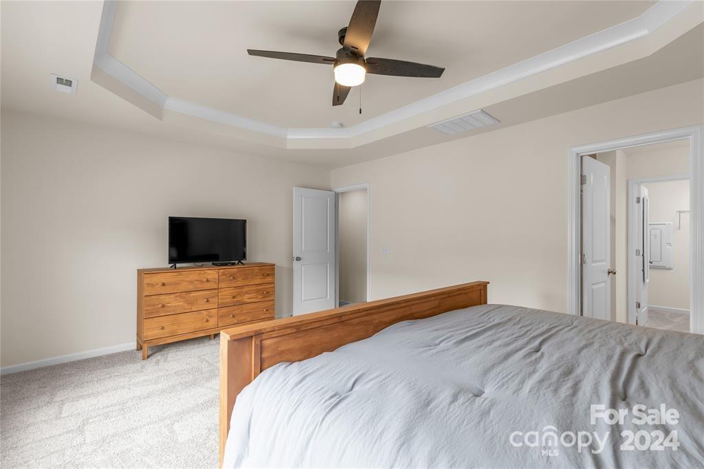 825 Canoe Song Road Fort Mill, SC 29708 - Photo 14 of 17 a bedroom with a bed and a flat screen tv