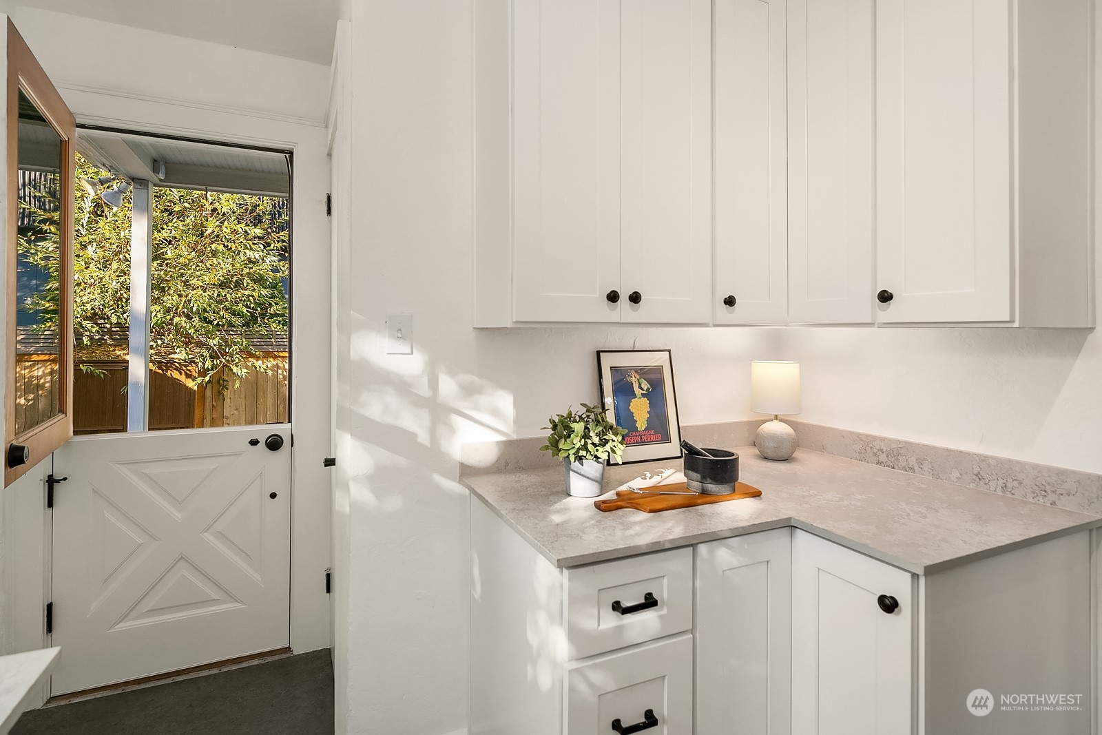 401 20th Avenue Seattle, WA 98122 - Photo 14 of 28 a view of kitchen with white cabinets and window
