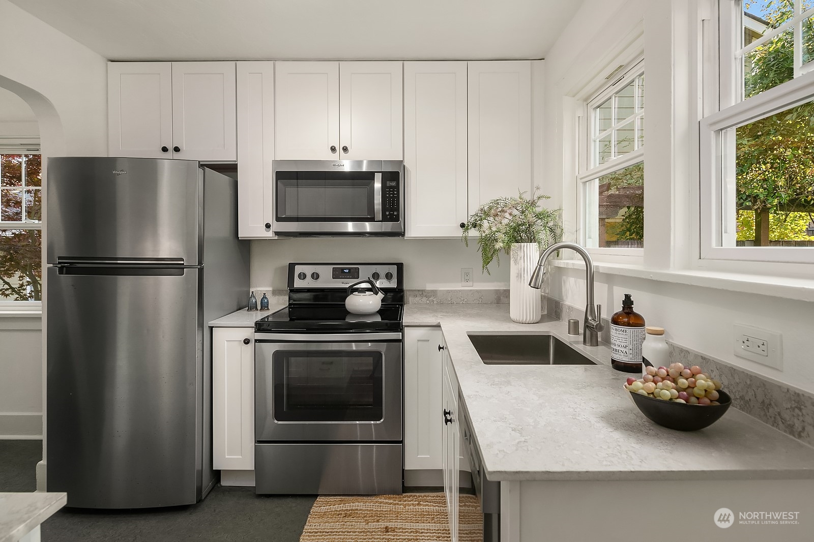 401 20th Avenue Seattle, WA 98122 - Photo 8 of 28 a kitchen with stainless steel appliances a stove a sink and a refrigerator