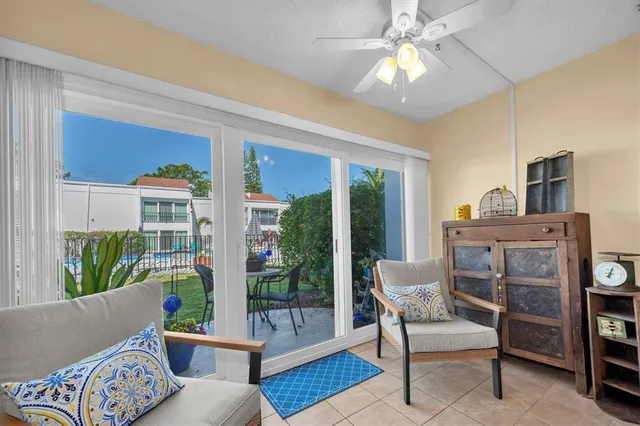 a living room with furniture and a floor to ceiling window