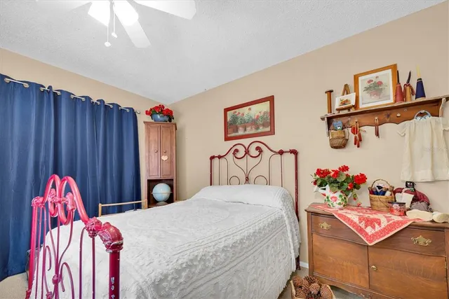 a bedroom with a bed and a painting on the wall