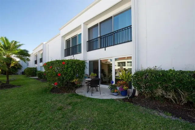 a view of a house with backyard sitting area and garden