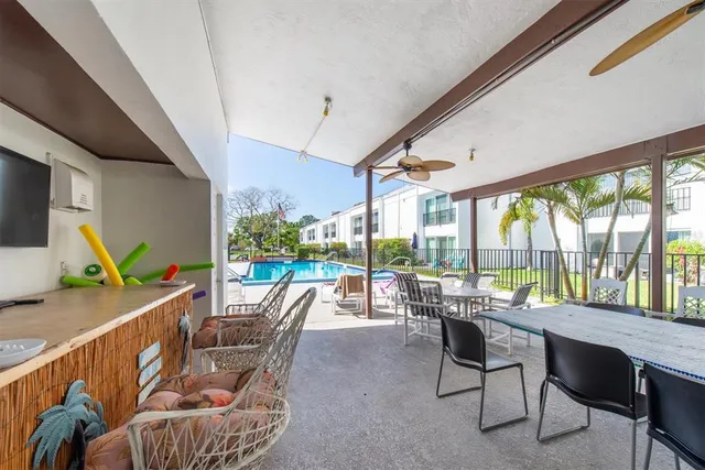 a dining room with furniture water view and a floor to ceiling window
