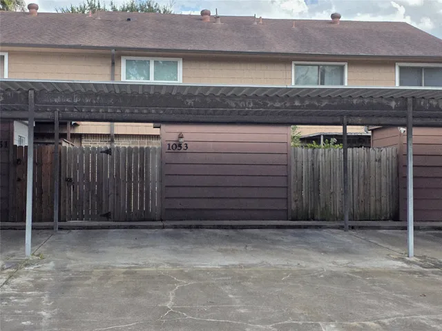 a view of a house with wooden fence