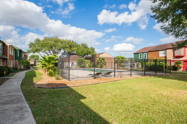 a view of a swimming pool and a yard