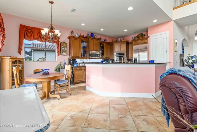 a view of a dining room with furniture and chandelier