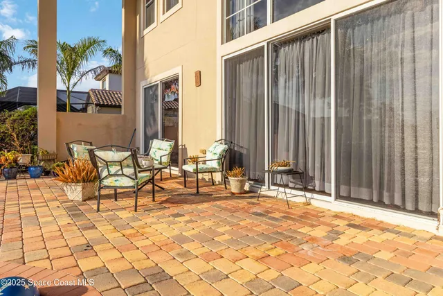 an aerial view of residential houses with yard and green space