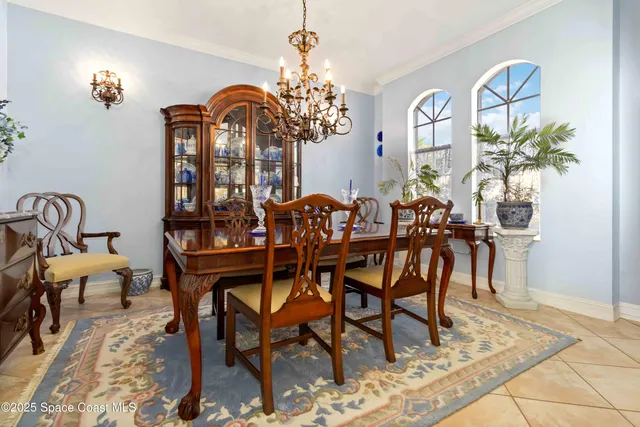 a view of a dining room with furniture and chandelier