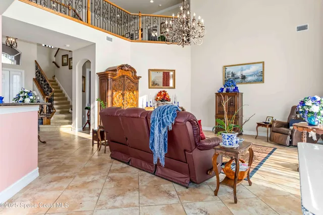 a living room with furniture and a chandelier