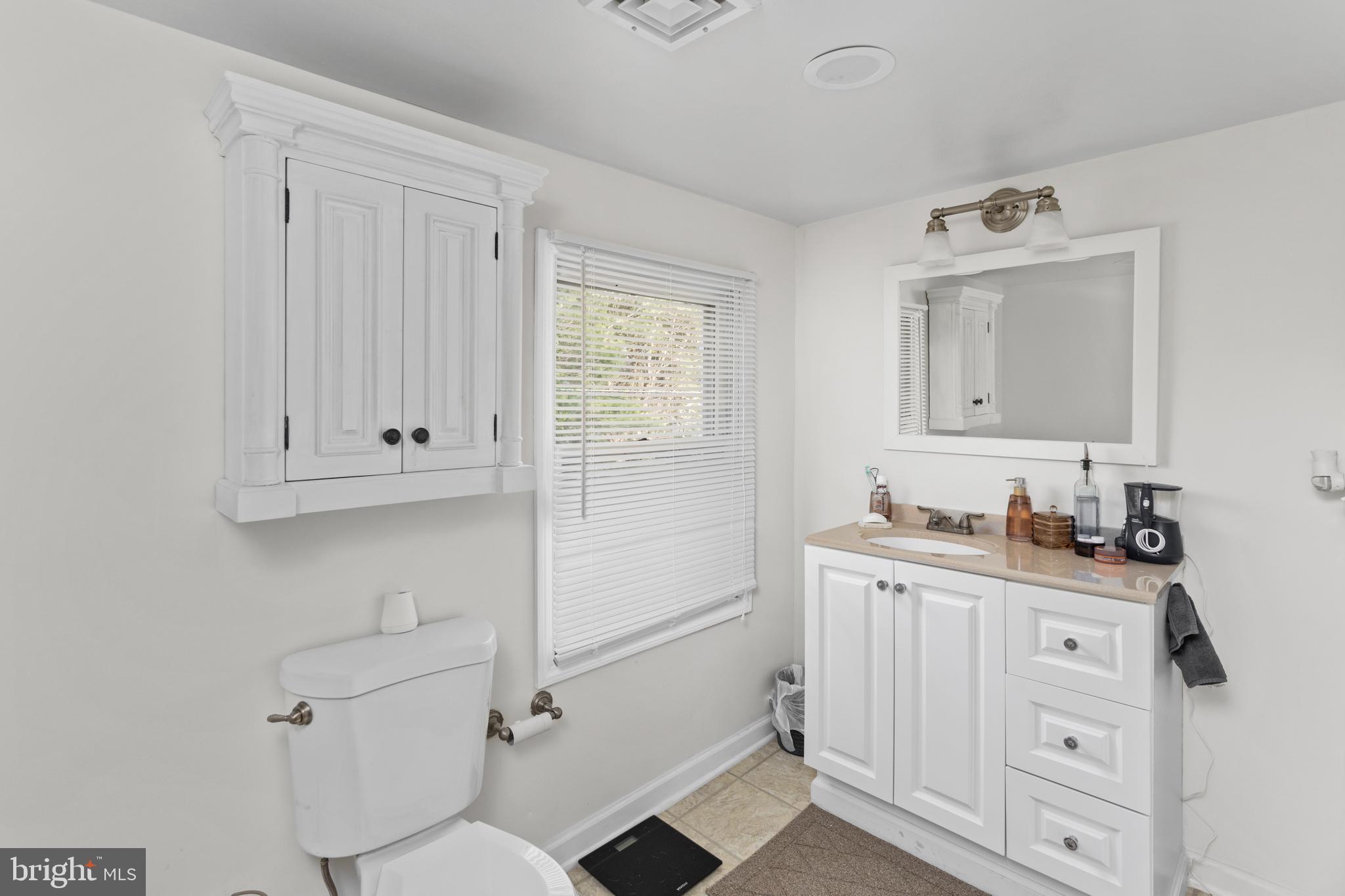942 Province Line Road Allentown, NJ 08501 - Photo 37 of 50 a bathroom with a granite countertop toilet sink and mirror