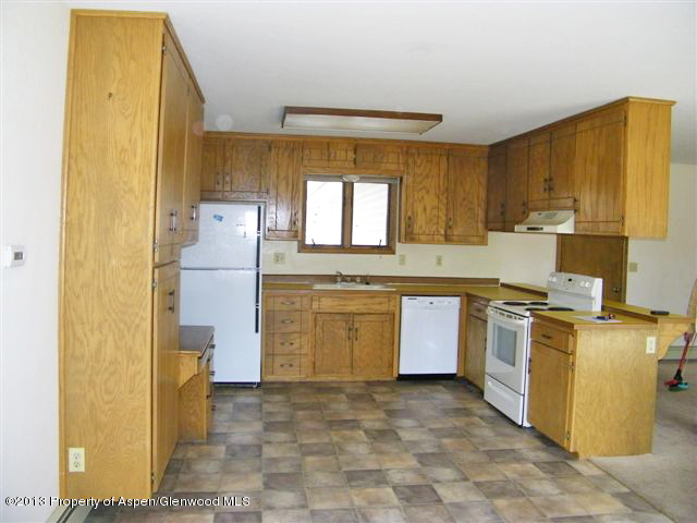 749 Cactus Court Rifle, CO 81650 - Photo 3 of 12 a kitchen with a stove a refrigerator and a sink