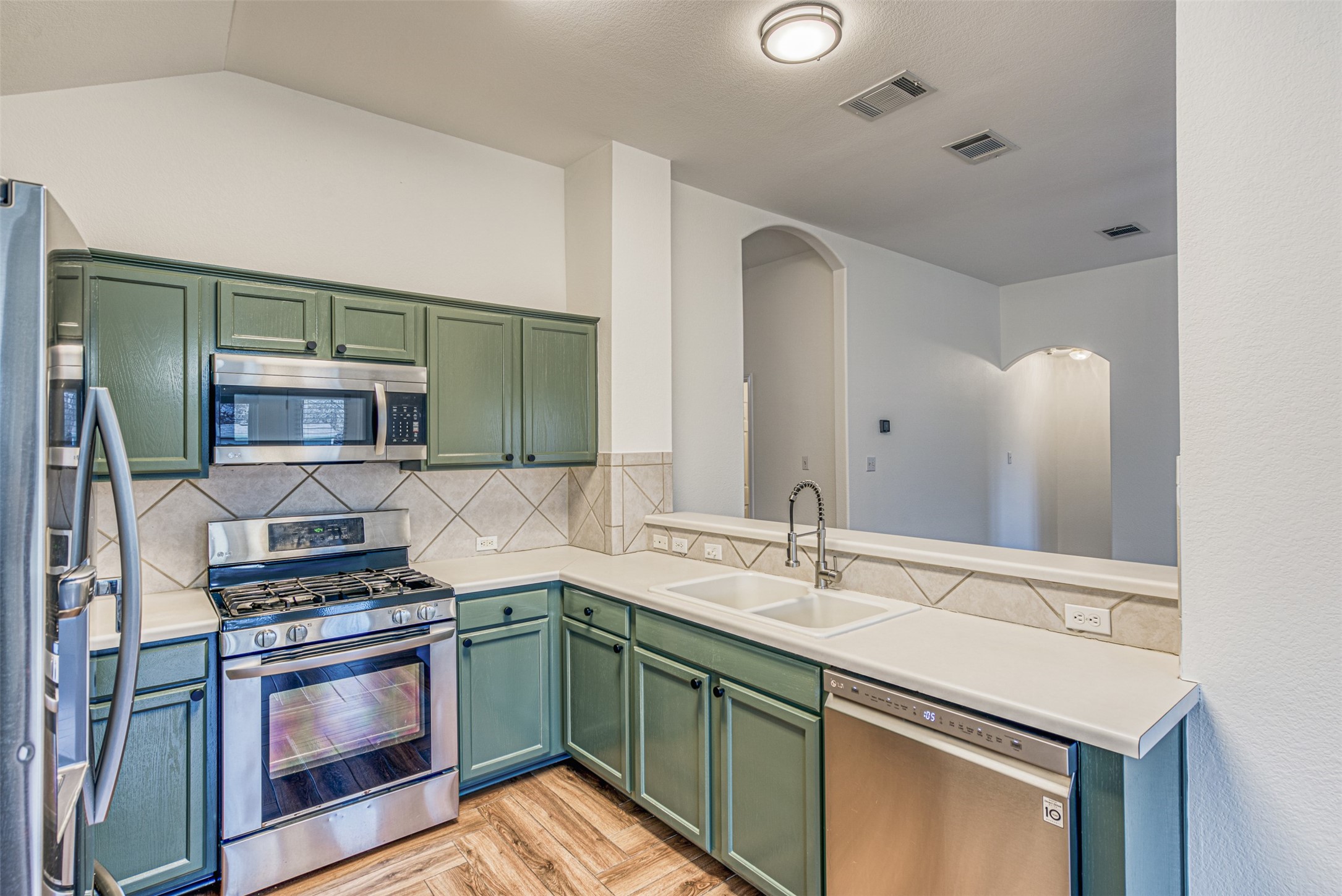 102 Chandler View Trail Round Rock, TX 78665 - Photo 11 of 26 a kitchen with stainless steel appliances granite countertop a sink and stove top oven