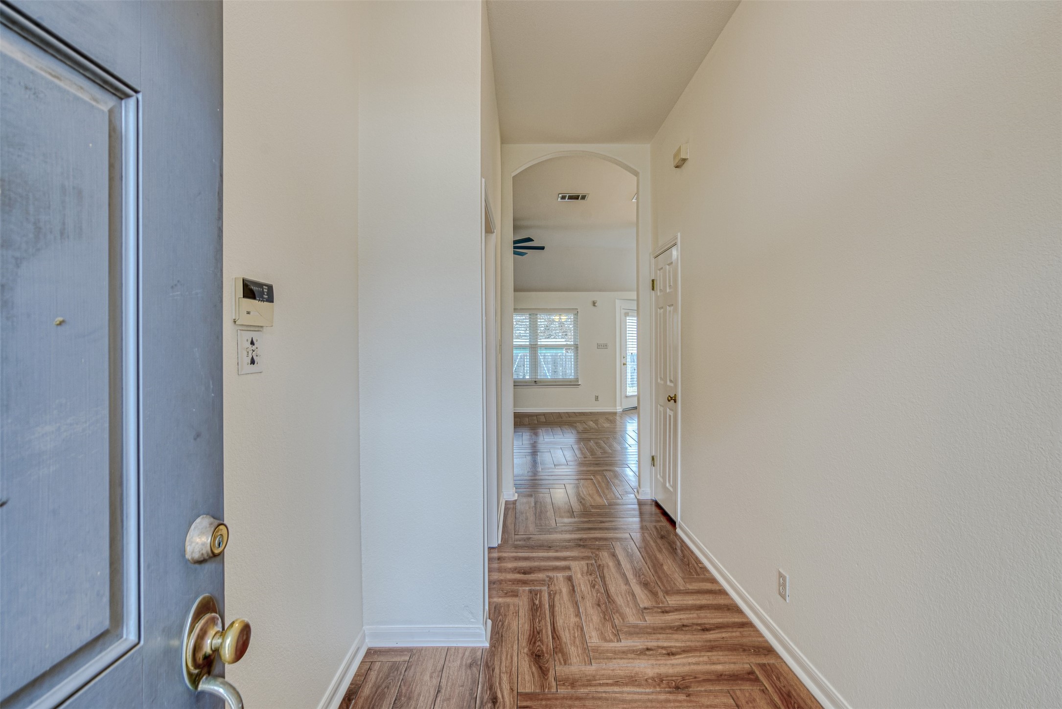 102 Chandler View Trail Round Rock, TX 78665 - Photo 4 of 26 a view of a hallway with wooden floor and a living room