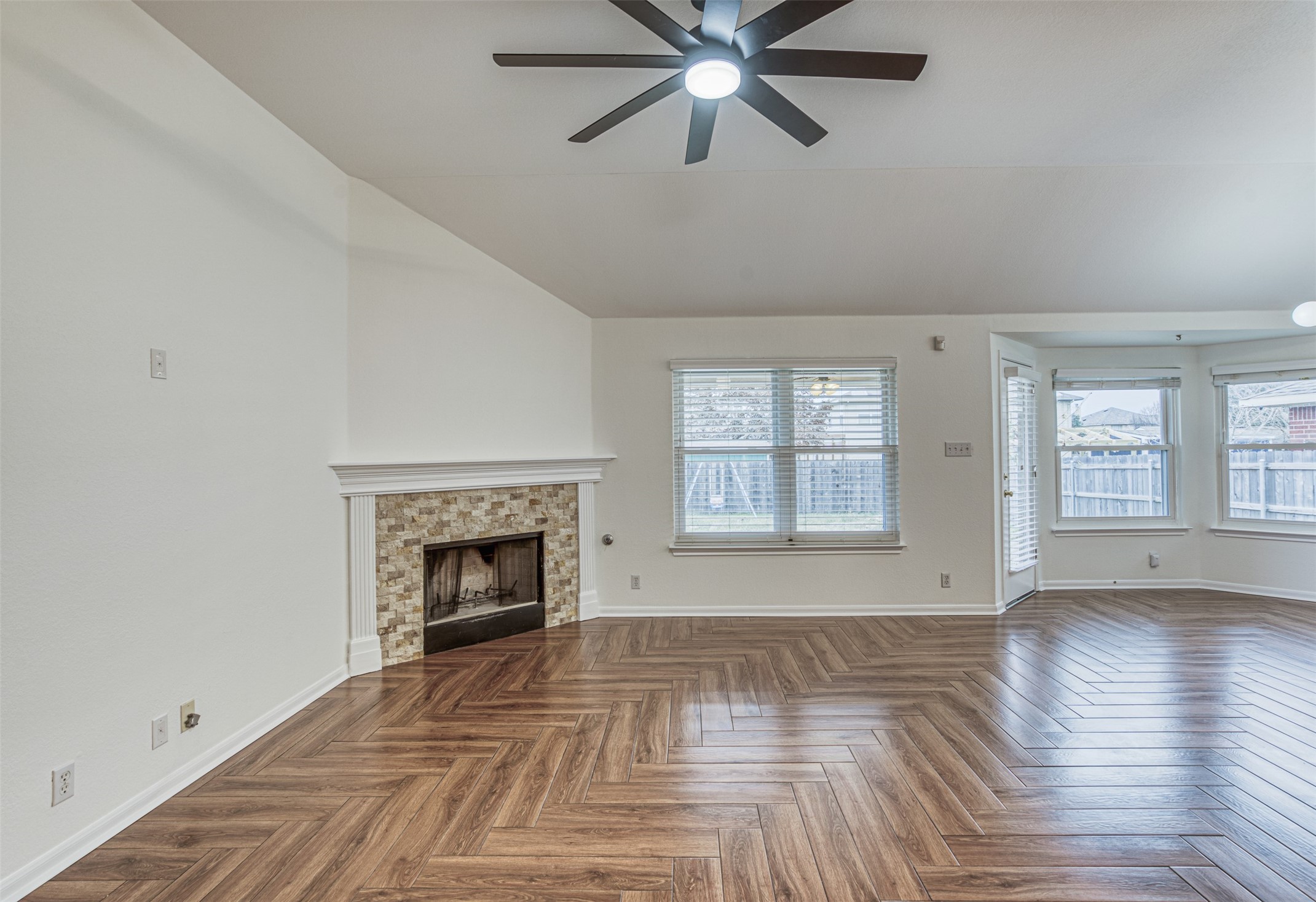 102 Chandler View Trail Round Rock, TX 78665 - Photo 6 of 26 wooden floor fireplace and windows in an empty room