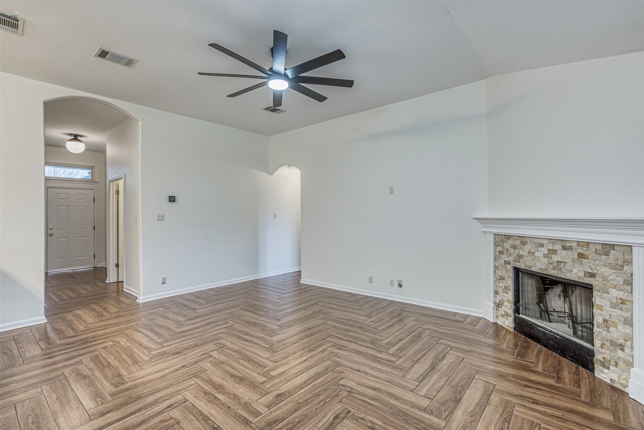 102 Chandler View Trail Round Rock, TX 78665 - Photo 8 of 26 a view of a livingroom with a fireplace a ceiling fan and wooden floor