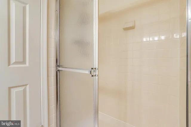 a bathroom with a glass shower door