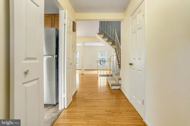 a view of a bathroom with mirror and shower