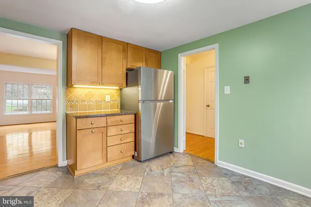 a kitchen with granite countertop cabinets and refrigerator