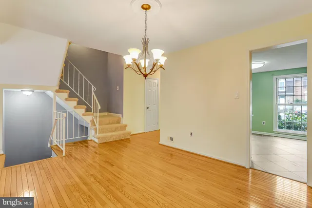a view of a room with wooden floor and staircase