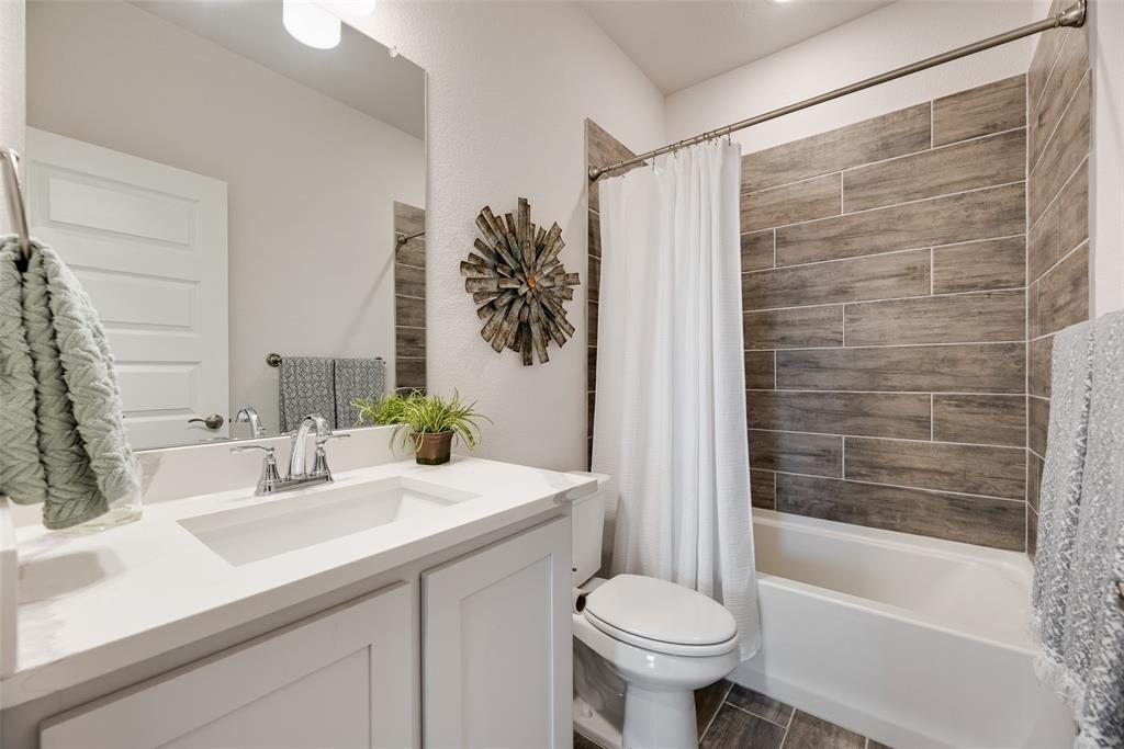 645 Mb Way South Pilot Point, TX 76258 - Photo 27 of 37 Secondary bath features a quartz vanity and tub-shower combo with stylish wood-look tile surround.