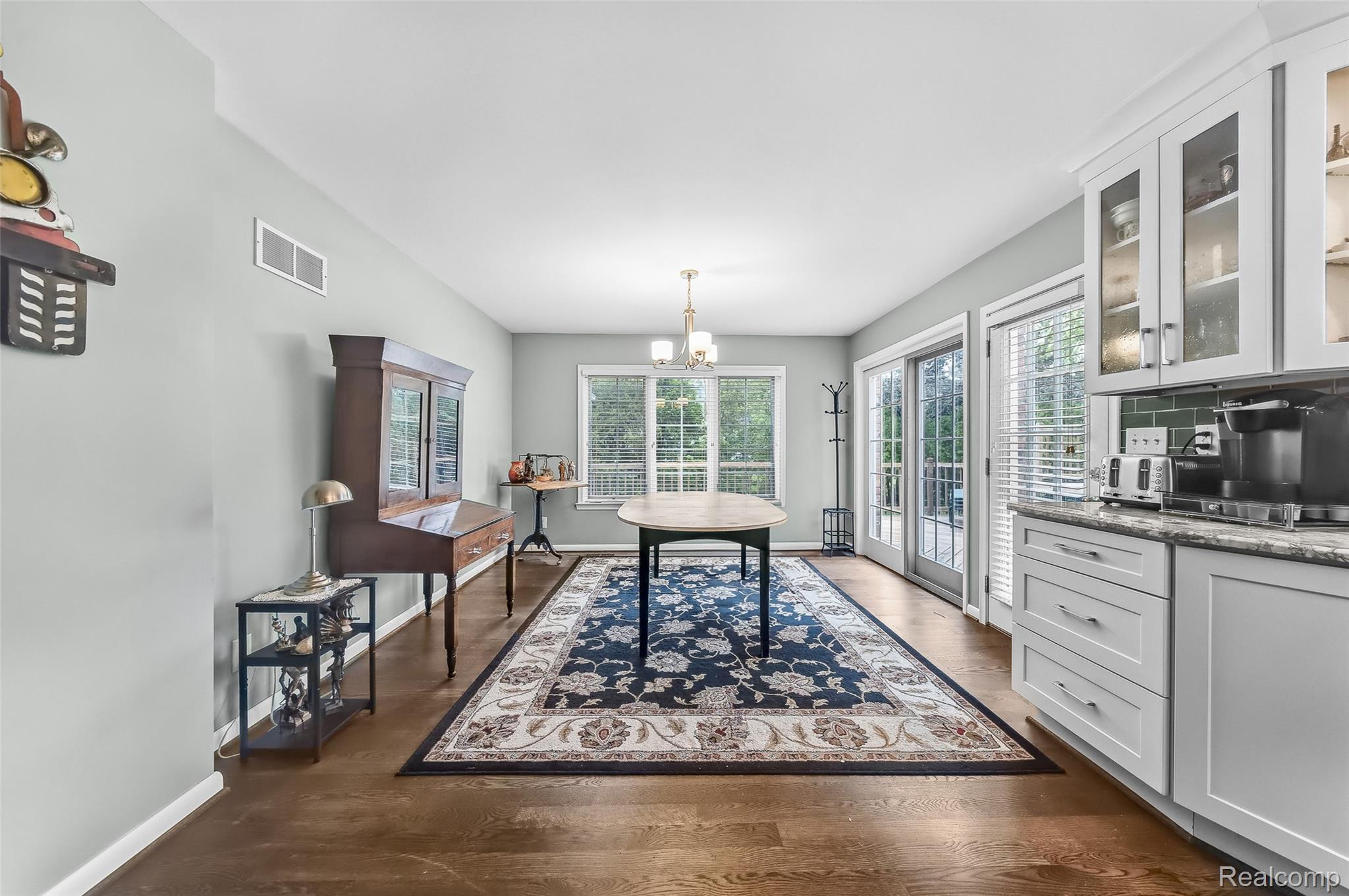 100 Overhill Road Bloomfield Hills, MI 48301 - Photo 11 of 55 Dining area featuring healthy amount of natural light, a chandelier, and dark wood-style flooring