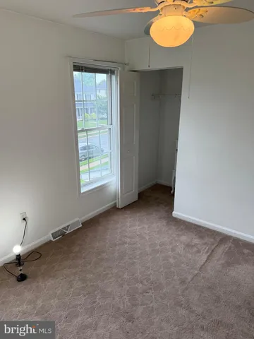 a view of an empty room and a window