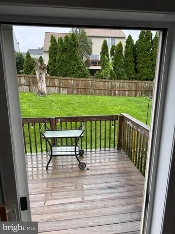 a view of a deck and yard with green space