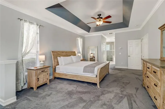 a spacious bedroom with a bed and a chandelier