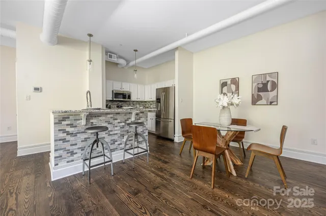 a dining room with furniture and wooden floor