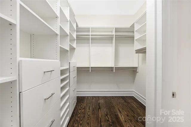 a view of walk in closet with empty racks
